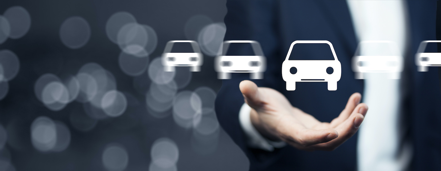 Un homme tient un pictogramme de voiture blanc dans sa main gauche